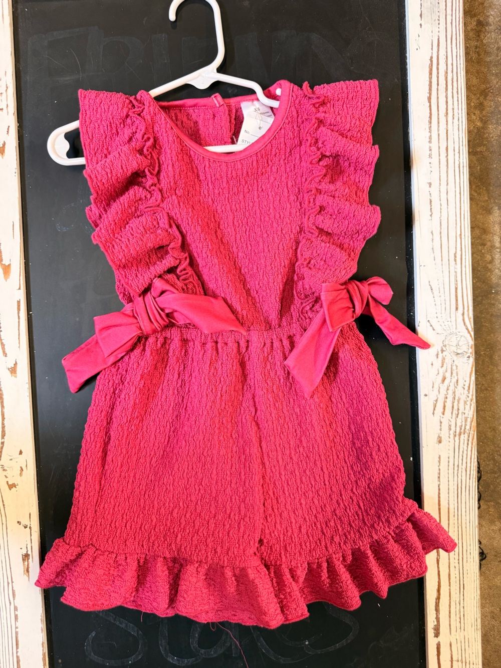 Pink Textured Sleeveless Romper with Bow Details